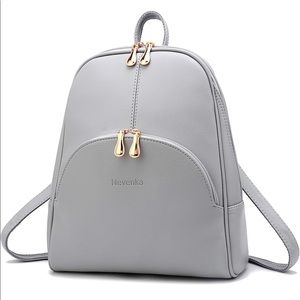 Backpack style purse with gold toned hardware